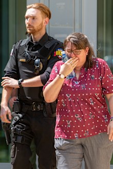 A woman cries Tuesday May 24, 2022 as she leaves the Uvalde Civic Center. 