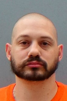 This undated file photo provided by the Arizona Department of Corrections shows Travis Ricci, a neo-Nazi whose murder trial in Phoenix ended with a mistrial on July 11, 2018. Ricci is accused of killing Kelly Ann Jaeger in October, 2009. Authorities say Ricci intended to shoot Jaeger's boyfriend, who is black, but instead fired fatal shotgun blasts at Jaeger, who is white. Ricci has pleaded not guilty to murder and other charges. (Arizona Department of Corrections via AP, file).