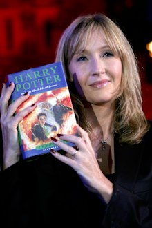 JK Rowling holding a Harry Potter book