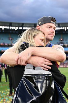 MELBOURNE, AUSTRALIA - SEPTEMBER 27: Lachie Neale of the Lions shares a moment with his wife Jules Neale after winning the AFL Grand Final match between Geelong Cats and Brisbane Lions at Melbourne Cricket Ground on September 27, 2025 in Melbourne, Australia. (Photo by Cameron Spencer/AFL Photos/via Getty Images)