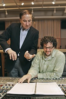 FILE - Composers Richard M. Sherman, left, who, along with his brother Robert, wrote the song "It's a Small World" for the Disneyland ride of the same name, and Michael Giacchino, right, who composed the driving music for Disneyland's newly-redesigned "Space Mountain" ride, work in a sound room at Walt Disney Imagineering offices in Glendale, Calif.,  July 5, 2005. Sherman, one half of the prolific, award-winning pair of brothers who helped form millions of childhoods by penning classic Disney t