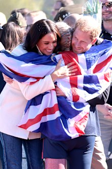 Prince Harry, Duke of Sussex and Meghan, Duchess of Sussex hug Lisa Johnston of Team United Kingdom at the Athletics Competition during day two of the Invictus Games The Hague 2020 at Zuiderpark on April 17, 2022 in The Hague, Netherlands. (Photo by Chris Jackson/Getty Images for the Invictus Games Foundation)