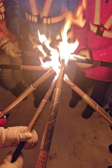 People light torches for a procession on the first day of Advent. 
