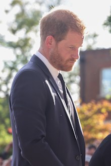 Prince Harry, Duke of Sussex looks at floral tributes laid by members of the public on the Long walk at Windsor Castle on September 10, 2022 in Windsor, England.