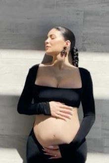 Kylie Jenner displays baby bump in pregnancy video.