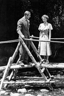 Princess Elizabeth and the Duke of Edinburgh on a bridge in the grounds of Sagana Lodge, their wedding present from the people of Kenya, 5th February 1952. The following day, news would arrive of the death of King George VI and Elizabeth's accession to the throne. (Photo by NCJ Archive/Mirrorpix/Mirrorpix via Getty Images)