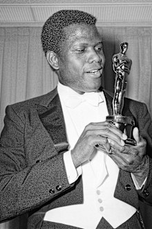 Actor Sidney Poitier poses with his Oscar for best actor for "Lillies of the Field" at the 36th Annual Academy Awards in Santa Monica, Calif. on April 13, 1964.  