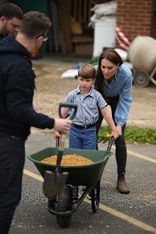 Prince Louis of Wales uses a wheelbarrow as he helps his mother, Catherine, Princess of Wales, take part in the Big Help Out, during a visit to the 3rd Upton Scouts Hut in Slough on May 8, 2023