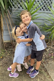 Roxy (left) with her big sister and brother towards the end of her treatment.