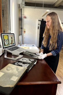 Camera Press owner and co-director Emma Blau showing Queen Elizabeth II coronation images used on magazine covers