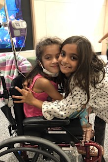 Meesha (left) during one of her many hospital stays as a young child.