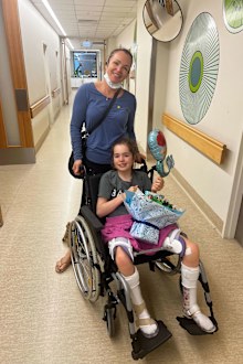 Eva Kalpidis leaving hospital in her Newport brace with mum Stacey.