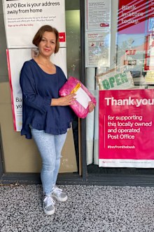 Fashion boutique owner Krys Charalambous drops off an order at her local post office.