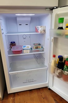 Fridge with small amount of groceries inside