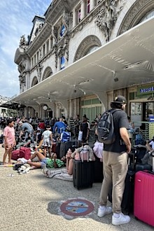 Stranded train passengers wait out delays outside Gare de Lyon in Paris on Wednesday July 31, 2024.