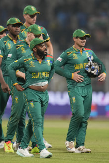 South Africa's captain Temba Bavuma with teammates walk off the field after losing to Australia.