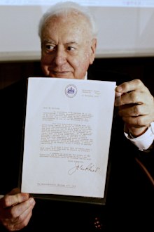 In this November 7, 2005 file photo, former Australian Prime Minister Gough Whitlam holds up the original copy of his dismissal letter he received from then Governor General Sir John Kerr on the 11th of November 1975 at a book launch in Sydney, Australia. Historian, Professor Jenny Hocking, is going to court this month in an attempt to force Australian authorities to release secret letters that would reveal what Queen Elizabeth II knew of her representative's sho