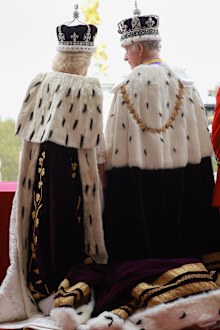 King Charles III and Queen Camilla watch the flypast from the balcony of Buckingham Palace after their Coronation on May 06, 2023 in London, England.