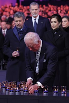 OSWIECIM, POLAND - JANUARY 27: British King Charles III places a lit a candle in tribute to victims of the Holocaust as King Felipe VI of Spain, King Frederik X of Denmark and Queen Mary of Denmark and Spain's King Felipe stand behind during the main ceremony for the 80th anniversary of the liberation of the Auschwitz camp on January 27, 2025 in Oswiecim, Poland. 