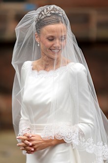 CHESTER, ENGLAND - JUNE 07: Olivia Henson smiles as she arrives for her wedding to Hugh Grosvenor, Duke of Westminster at Chester Cathedral on June 07, 2024 in Chester, England. (Photo by Chris Jackson/Getty Images)