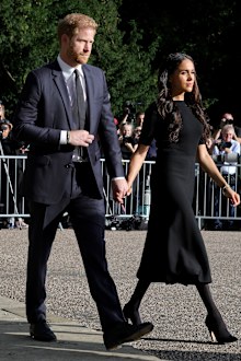 Prince Harry, Duke of Sussex, and Meghan, Duchess of Sussex on the long Walk at Windsor Castle arrive to view flowers and tributes to HM Queen Elizabeth on September 10, 2022 in Windsor, England.  