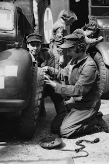 Princess Elizabeth changing the tire of a vehicle as she trains at as ATS Officer during World War Two, at the ATS training centre in England, April 18th 1945. (Photo by Central Press/Hulton Archive/Getty Images)