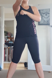 She exercises at home with her children by her side.