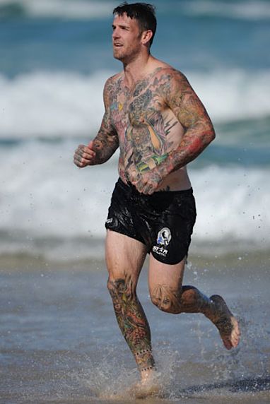 Swan's tattoos reach across his entire body. (Getty)