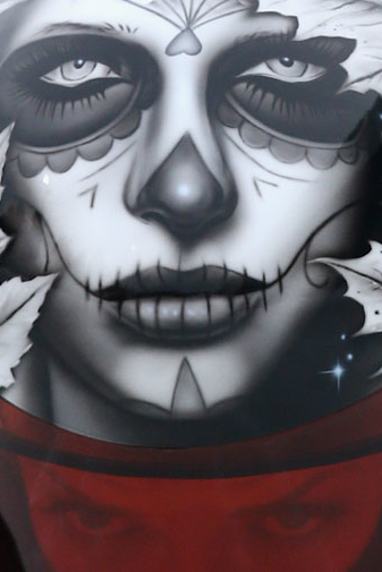 Reid's is the face of a stylized corpse with a Maple Leaf backdrop.