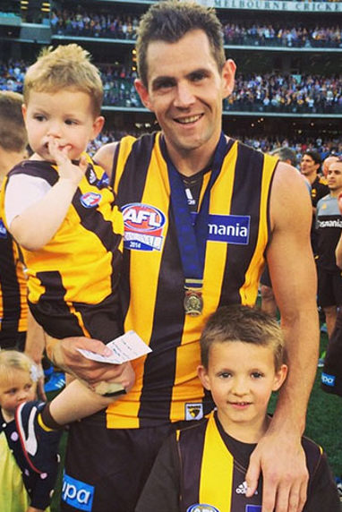 Hodge celebrates his second Norm Smith Medal with his family.