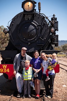 Broly Blackmore with his family in front of a steam train.