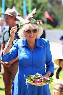 Queen Camilla tries on a local garland at the Premier's Community Barbeque at Parramatta Park on October 22, 2024 in Sydney, Australia. The King's visit to Australia is his first as monarch, and the Commonwealth Heads of Government Meeting (CHOGM) in Samoa will be his first as head of the Commonwealth.
