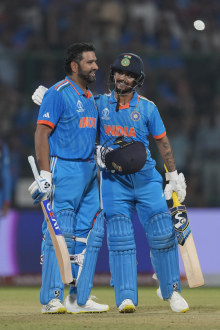 India's captain Rohit Sharma celebrates his century with teammate Ishan Kishan.