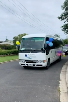 Decked out in balloons, and a loudspeaker, a convey of vehicles drove past students' homes.