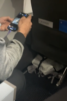 Man taking photos of womans feet flight