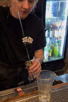 bartender using measuring device for nip