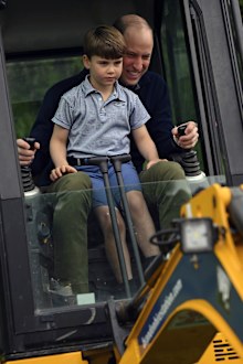 Prince William is helped by Prince Louis as he uses an excavator while taking part in the Big Help Out, during a visit to the 3rd Upton Scouts Hut in Slough, England, Monday, May 8, 2023