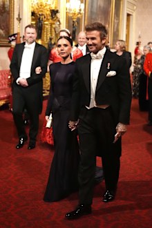 Victoria and David Beckham make their way along the East Gallery to attend the State Banquet at Buckingham Palace during day one of The Amir of the State of Qatar's visit to the United Kingdom on December 3, 2024 in London, England. His Highness Sheikh Tamim bin Hamad Al Thani, Amir of the State of Qatar, accompanied by Her Highness Sheikha Jawaher bint Hamad bin Suhaim Al Thani, will hold several engagements with The Prince and Princess of Wales, The King and Queen