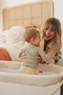 Elyse Knowles with her baby Sunny in the Fisher Price Bassinet. 