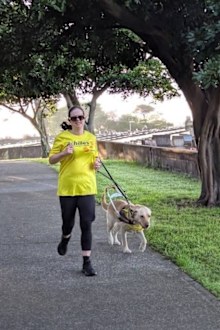 Nicole Tillotson running with her Seeing Eye Dog Trixie