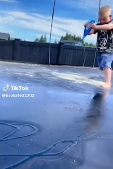 Toddler playing on slippery trampoline. 