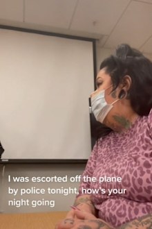 Woman police interview escorted from flight