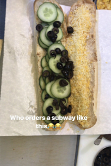 Subway sandwich with cucumber olives and cheese