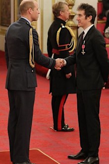 Prince Harry presenting Geraint Thomas with his OBE 