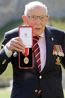 Captain Sir Thomas Moore poses after being awarded with the insignia of Knight Bachelor by Queen Elizabeth II at Windsor Castle on July 17, 2020 in Windsor, England. 