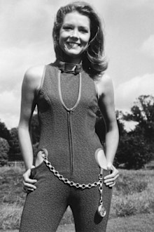 English actress Diana Rigg wearing a violet-coloured catsuit with cut-away hips, one of her costumes from the new series of 'The Avengers', 5th September 1966