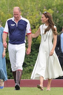 Prince William, Duke of Cambridge and Catherine, Duchess of Cambridge cross the pitch after the Royal Charity Polo Cup 2022 at Guards Polo Club 