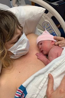 Valeri Hedges holds her newborn daughter Adrienne shortly after she gave birth in May. She had to wear a mask the entire time she was in the hospital because of the coronavirus pandemic