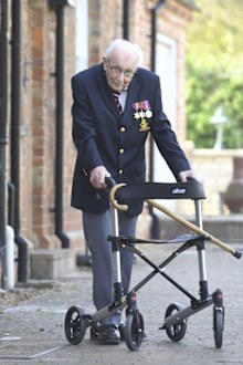 99-year-old war veteran Captain Tom Moore, poses for a photo at his home in Marston Moretaine, England, after he achieved his goal of 100 laps of his garden