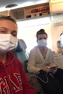 Women wearing facemasks on plane